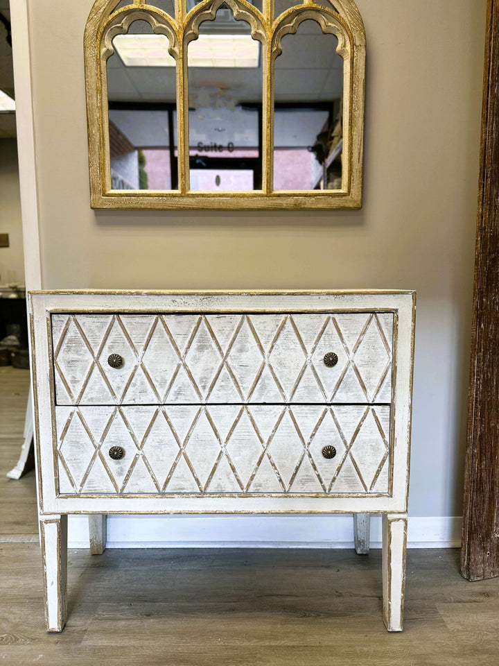 Vintage dresser with diamond pattern and distressed white finish, featuring two drawers and rustic charm.
