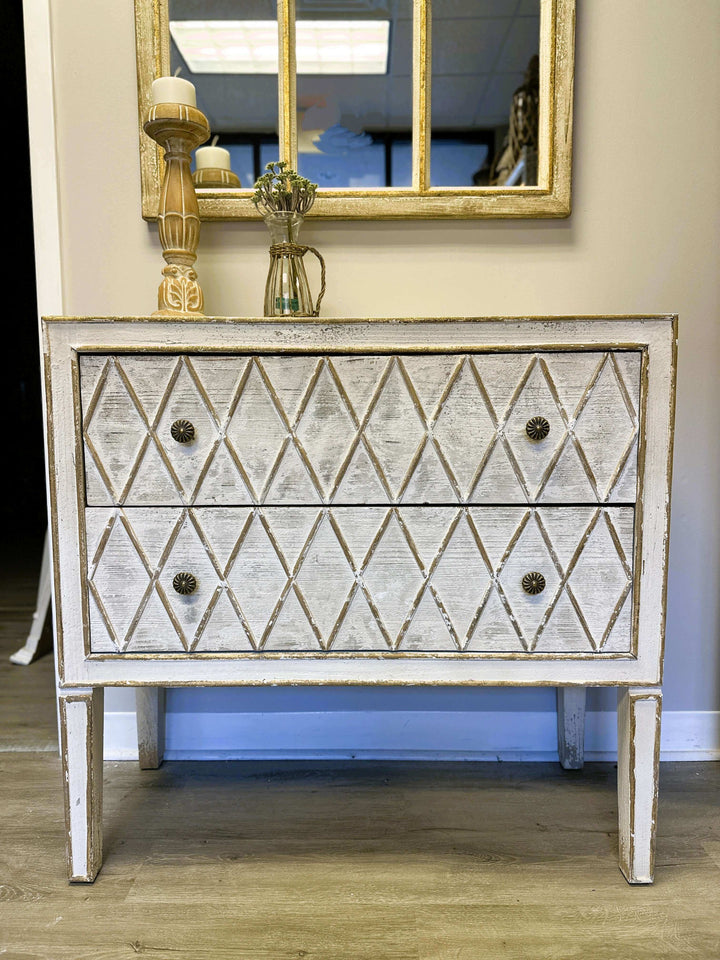 Vintage dresser with hand-carved diamond pattern and distressed white finish, ideal for adding rustic charm to any space.