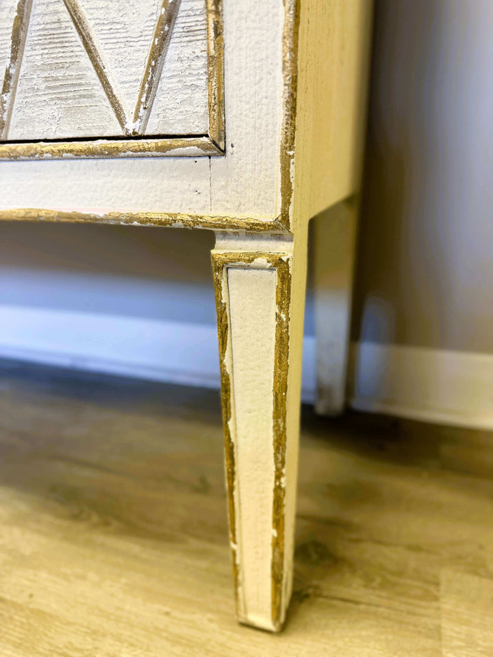 Close-up of the distressed white finish and hand-carved details on a Vintage Dresser with Diamond Pattern.
