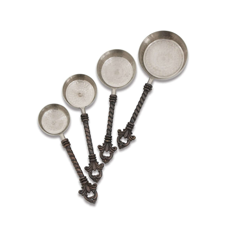 Set of decorative measuring spoons with twisted handles on a white background