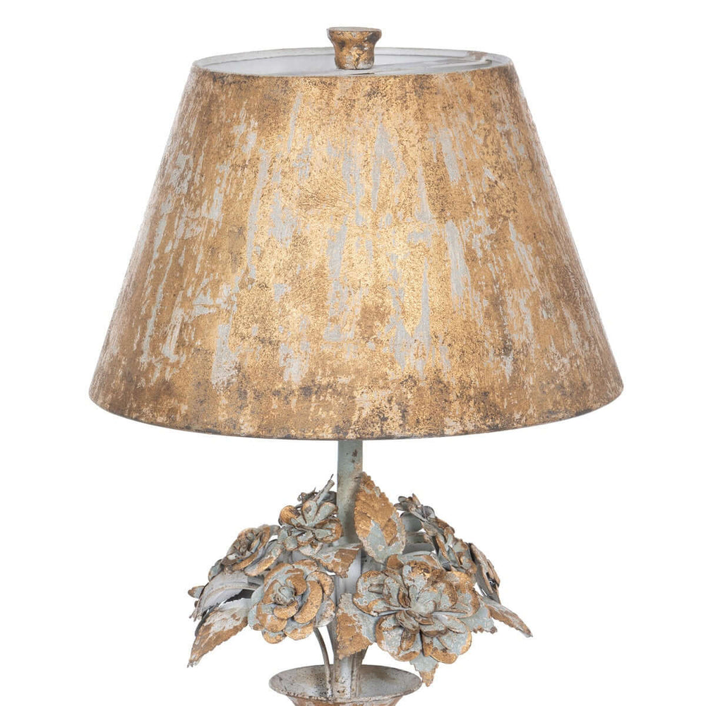 Decorative table lamp with a textured brown shade and flower-like base on a white background