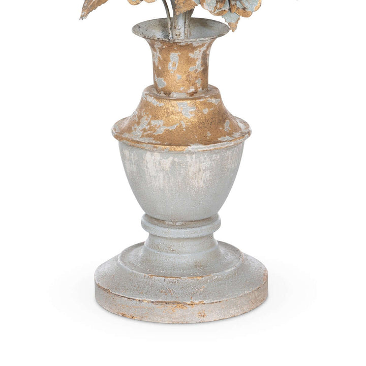 Decorative urn shaped lamp base with floral elements on a white background