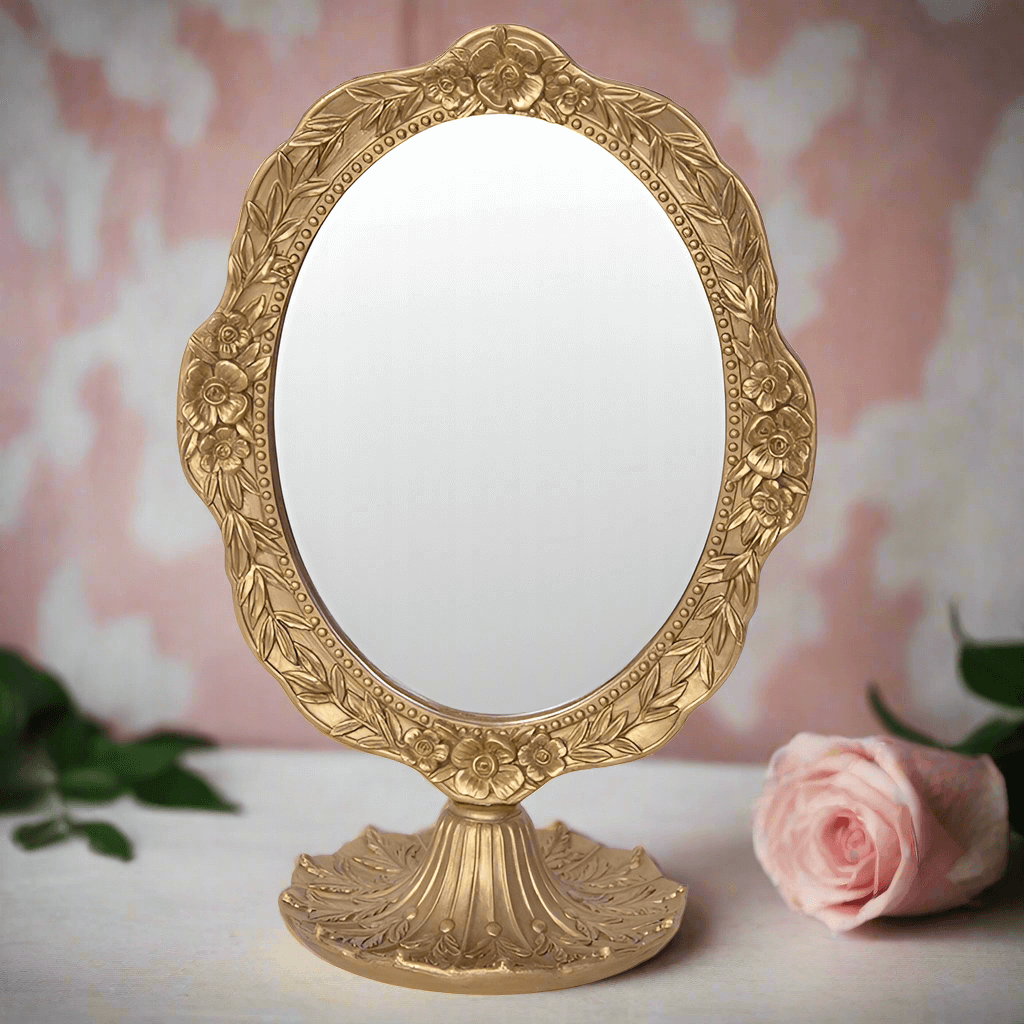 Vintage gold oval vanity mirror with ornate floral design, perfect for elegant home decor.
