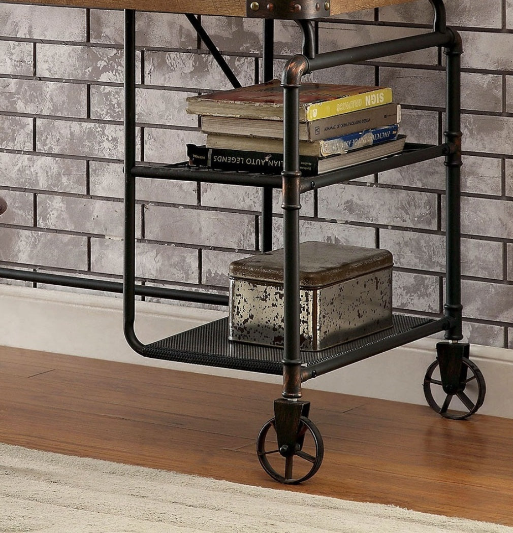Industrial-style metal desk with books and a box against a brick wall.