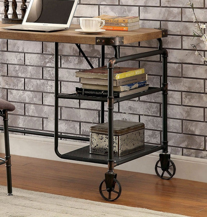 Industrial-style desk with books and a laptop against a brick wall.