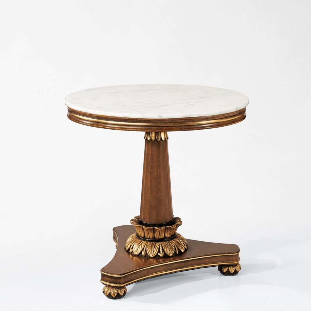 Round marble-top table with gold decorative base on a white background