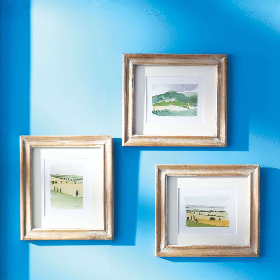 Vintage Italian Countryside Watercolor Wall Art hung on a blue wall with shadows