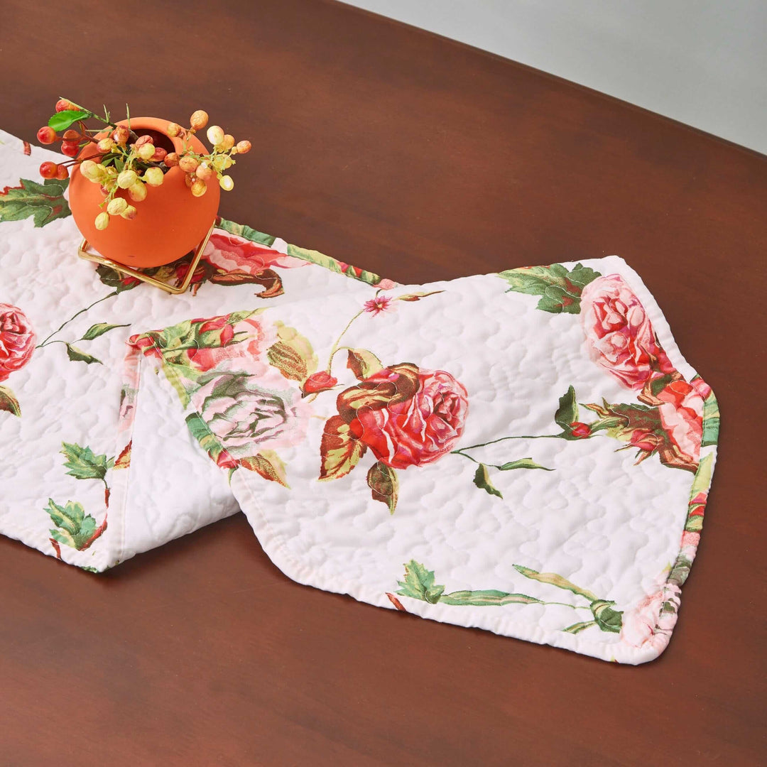 DaDa Bedding Romantic Roses Pink White Lovely Floral Quilted Dining Table Runner (879) on a wooden table with floral design.