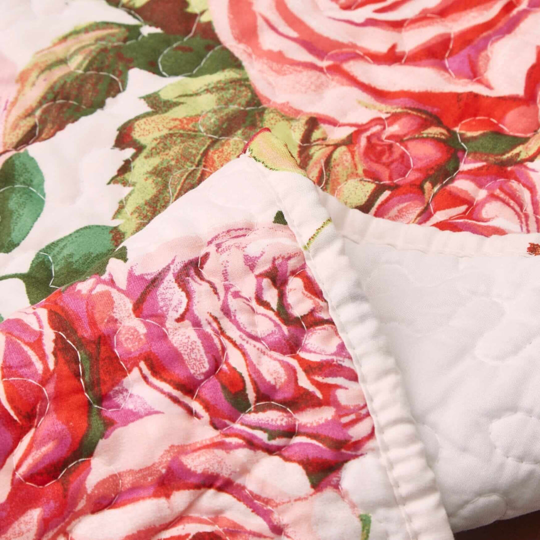 Close-up of DaDa Bedding Romantic Roses Pink White Lovely Floral Quilted Dining Table Runner (879) showcasing blooming rose patterns.