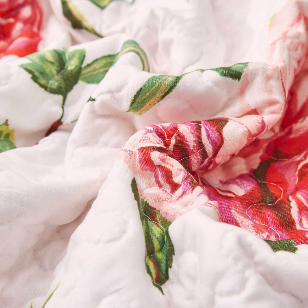 Close-up of DaDa Bedding Romantic Roses Pink White Lovely Floral Quilted Dining Table Runner (879) with pink roses on white fabric