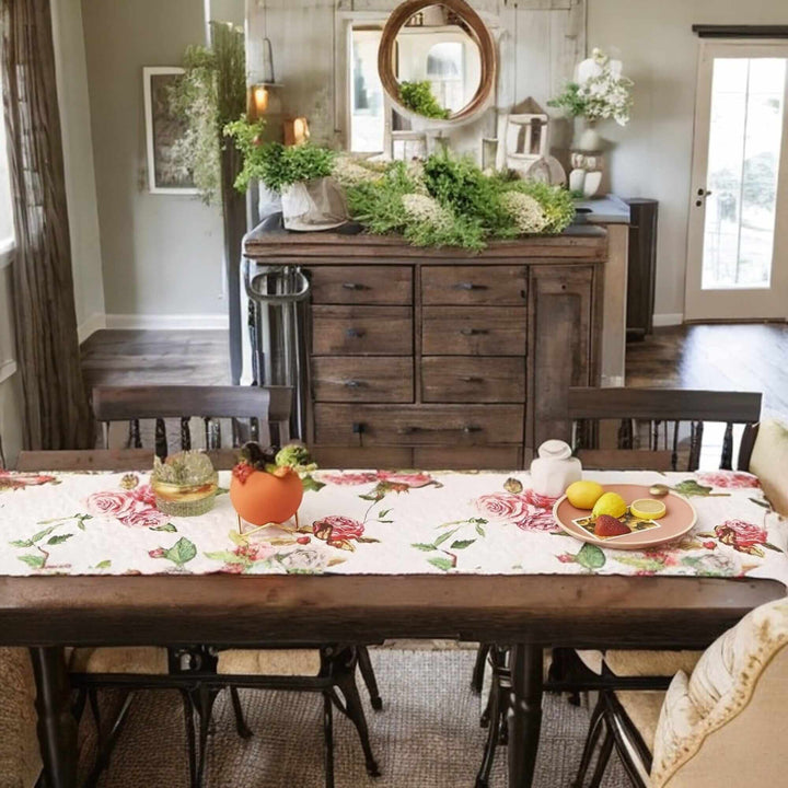 Dining table with DaDa Bedding Romantic Roses Pink White Lovely Floral Quilted Table Runner (879) featuring blooming rose patterns.