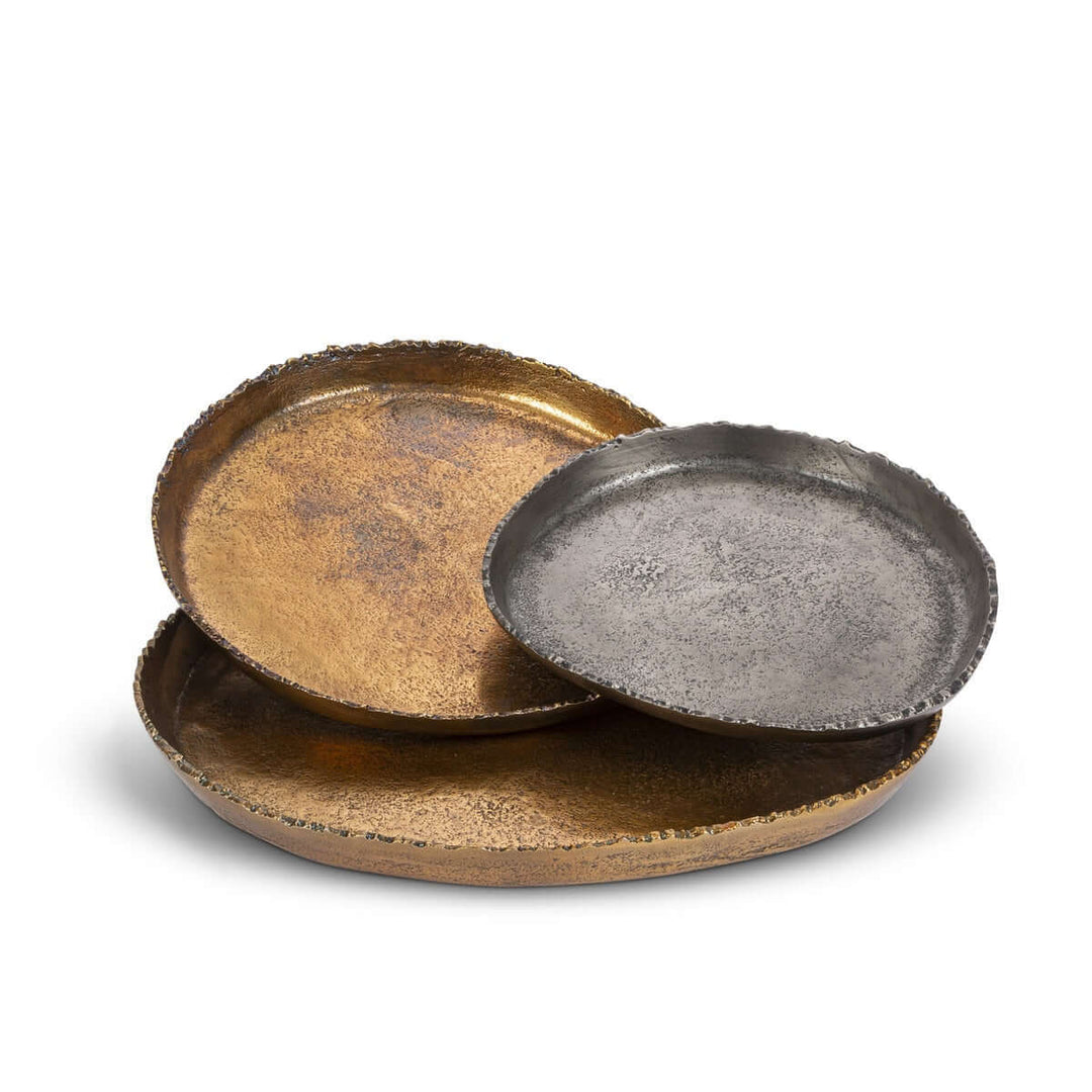 Three metallic trays in different finishes on a white background