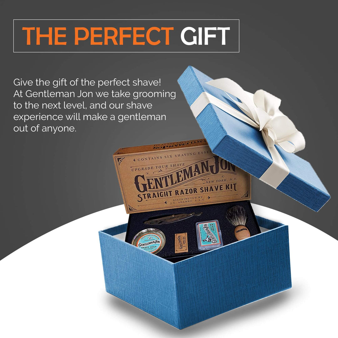 Gentleman Jon straight razor shave kit in a blue gift box with a white bow on a gray background.