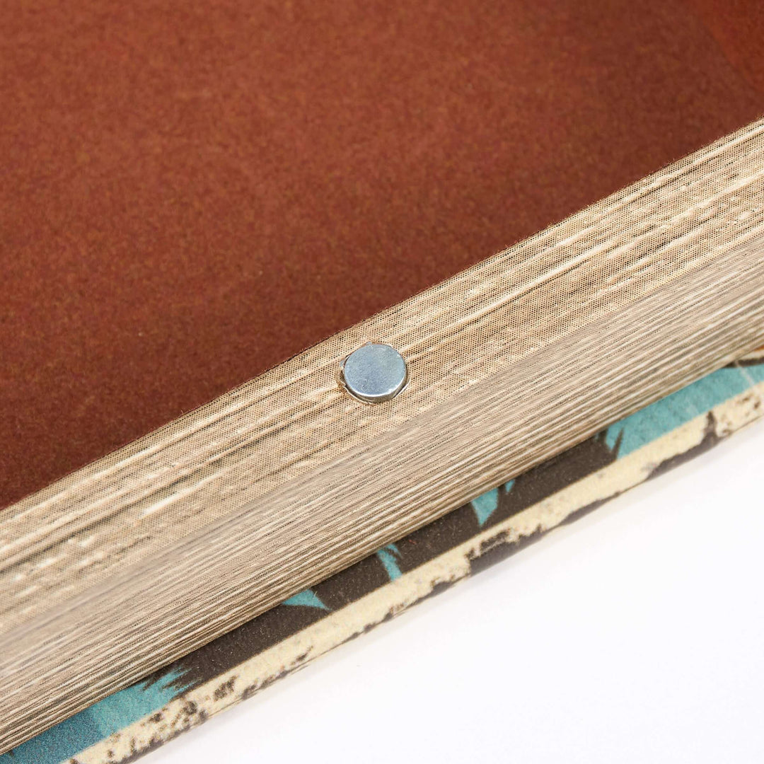 Close-up of a wooden frame with a metal screw on a brown background