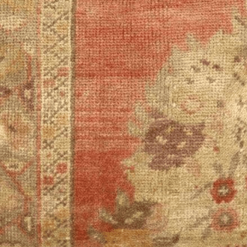 Decorative pillow with floral pattern and red background on a white background