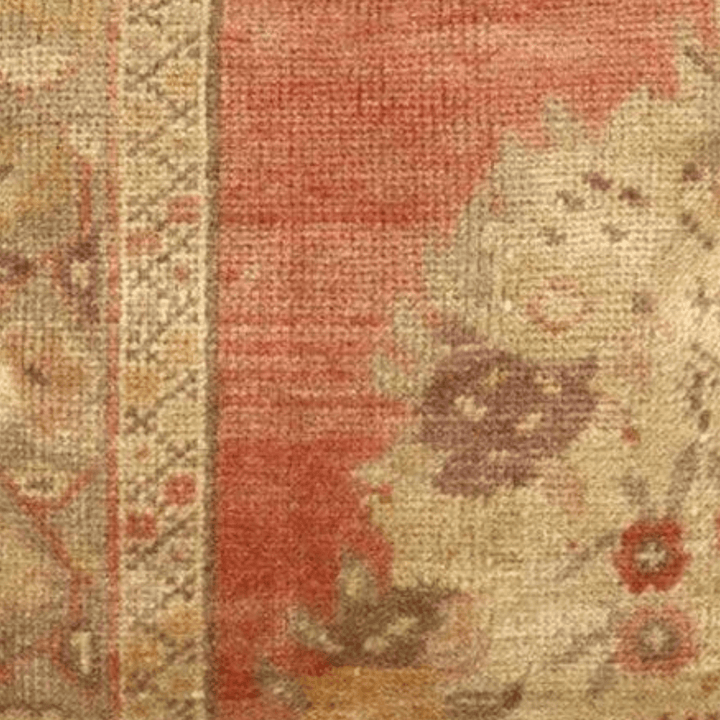 Decorative pillow with floral pattern and red background on a white background