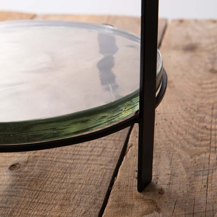 Glass on a metal stand on a wooden surface
