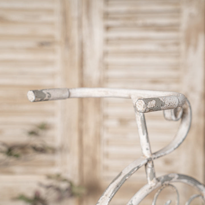 Close-up of a bicycle handlebar with a blurred natural background