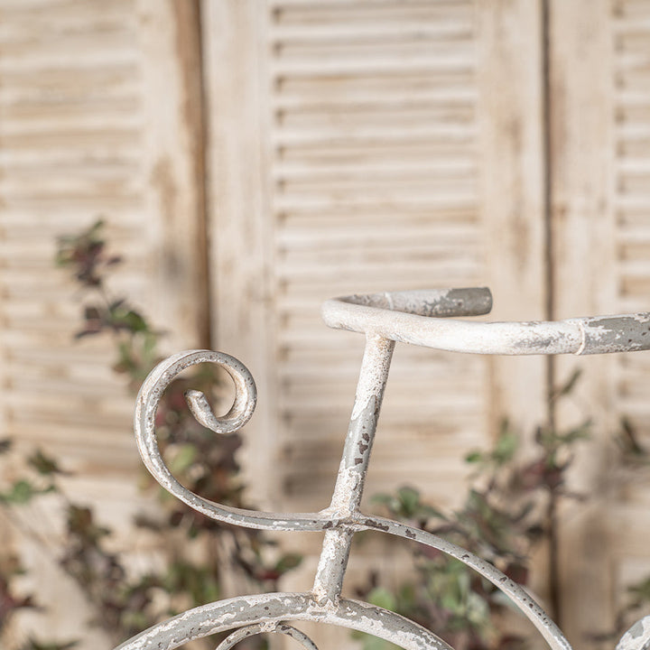 Decorative metal handle with a rustic finish against a wooden background
