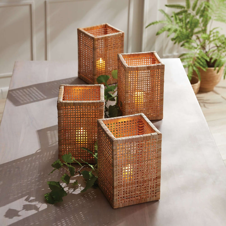 Four Vintage Woven Rattan Hurricane Candle Holders placed on a table