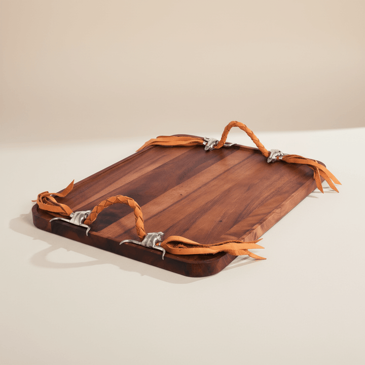 Wooden tray with leather straps on a beige background
