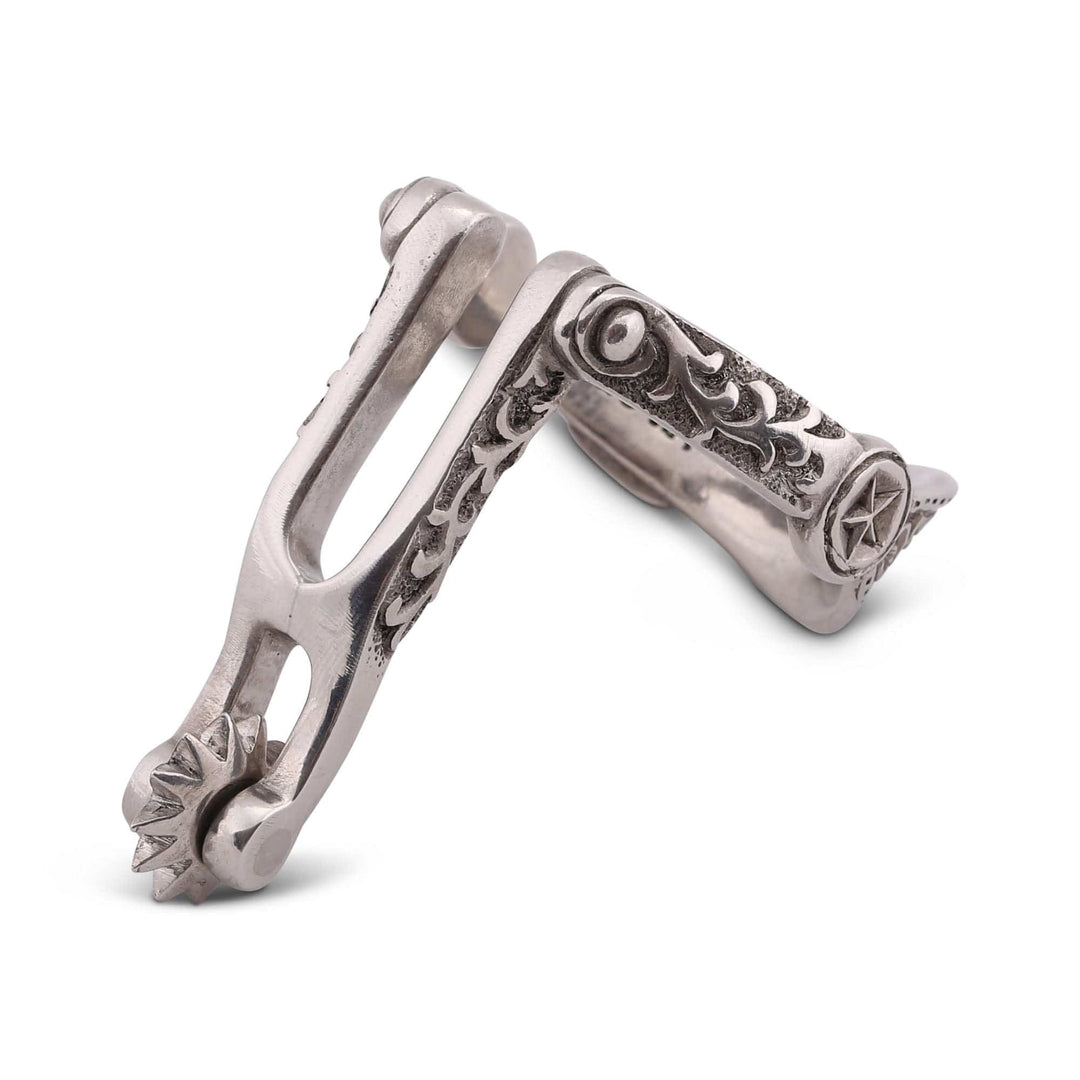Silver spur napkin ring with intricate designs on a white background
