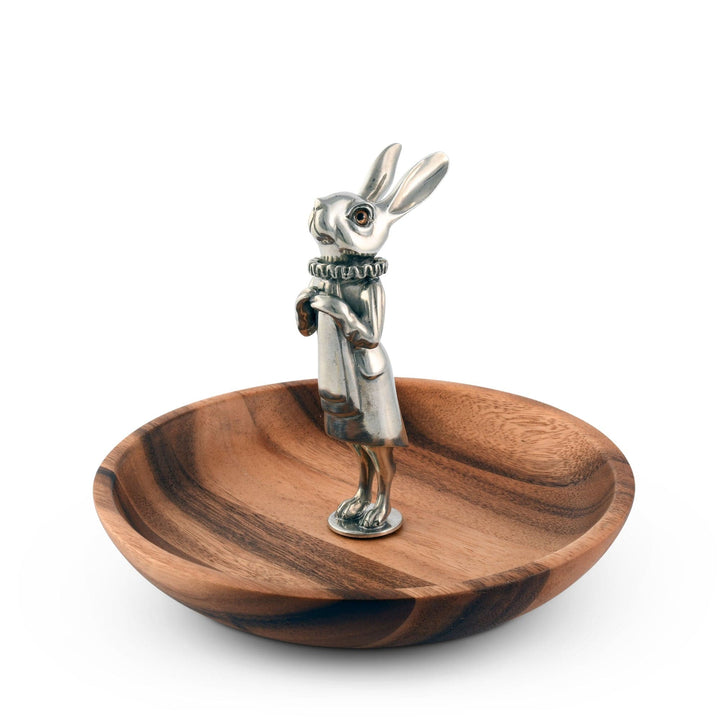 Wooden bowl with a silver rabbit figurine on a white background