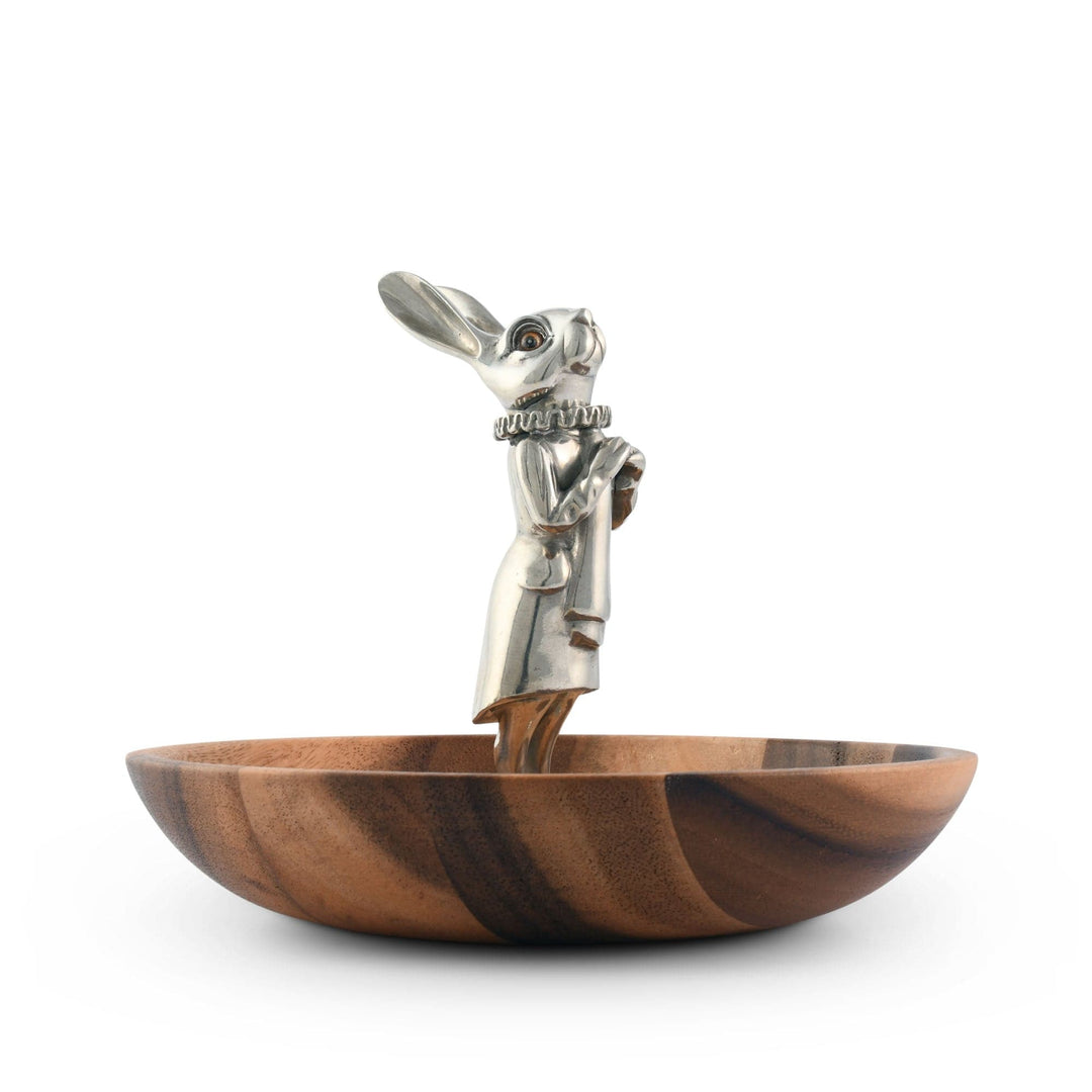 Wooden bowl with a metal rabbit on a white background