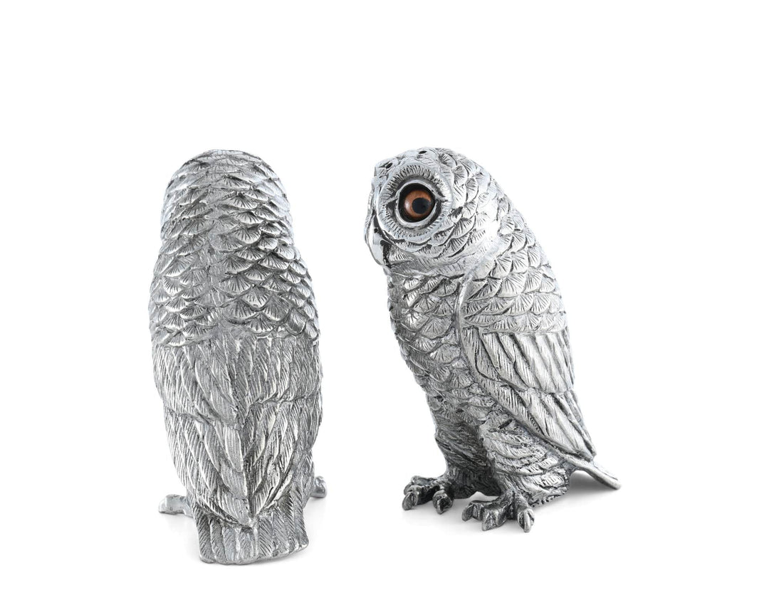 Silver owl figurine on a white background