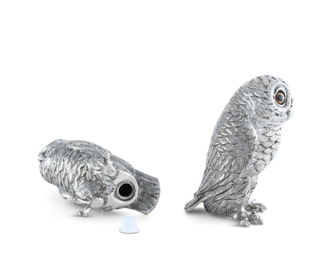 Silver owl figurine on a white background