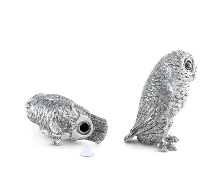 Silver owl figurine on a white background