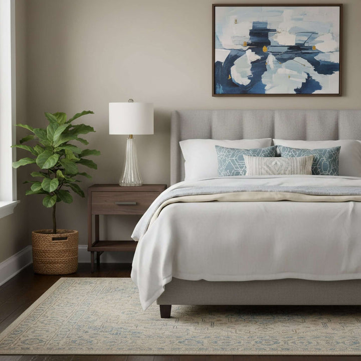 Neatly made bed with decorative pillows in a bedroom setting.