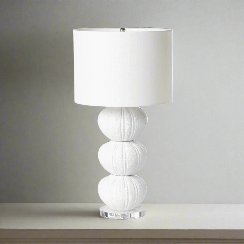 White table lamp with a textured base on a neutral background