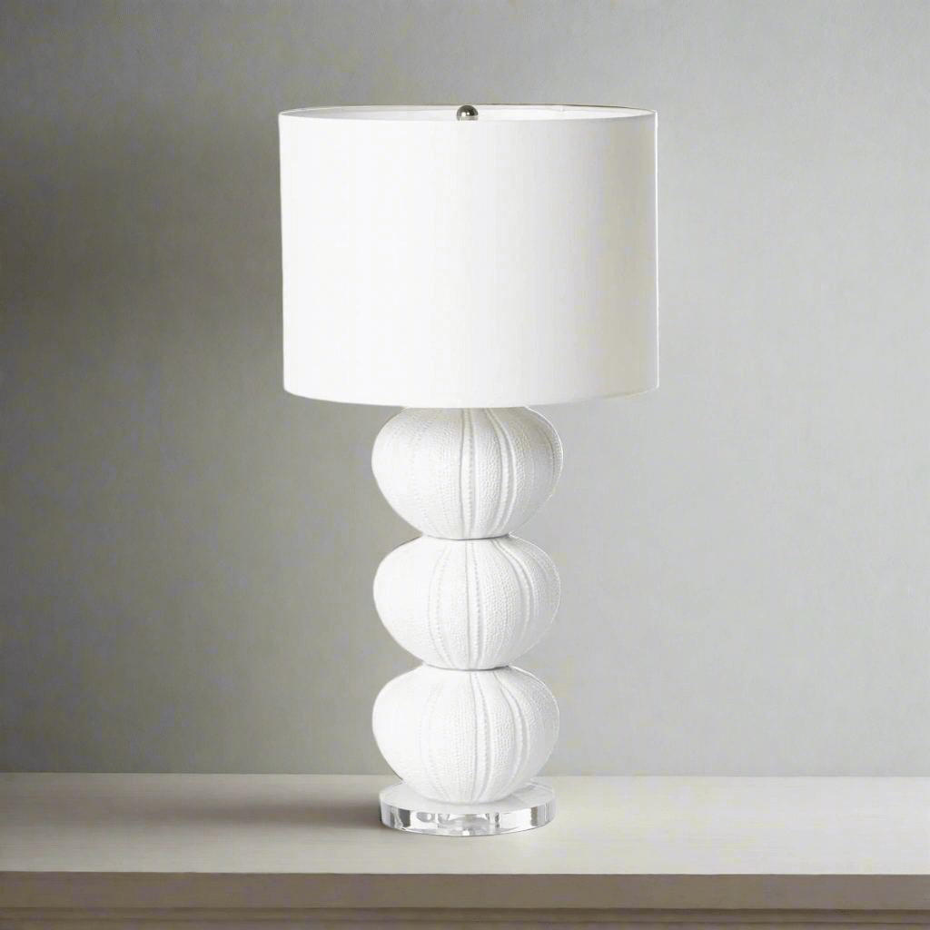 White table lamp with a textured base on a neutral background