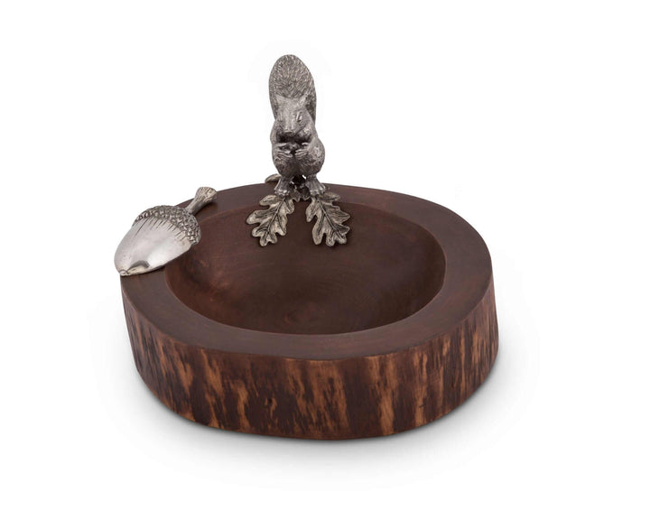 Decorative wooden bowl with metal squirrel and acorn figurines on a white background