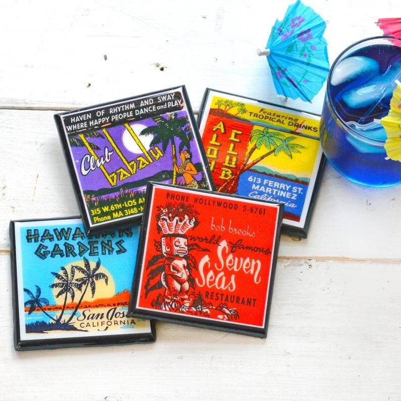 Set of colorful vintage-style coasters with different designs on a white surface.