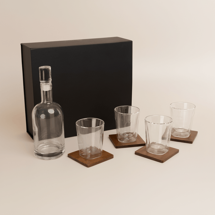 Old World Whiskey Decanter and Glass Set in Faux Leather Case with four glasses on wooden coasters.