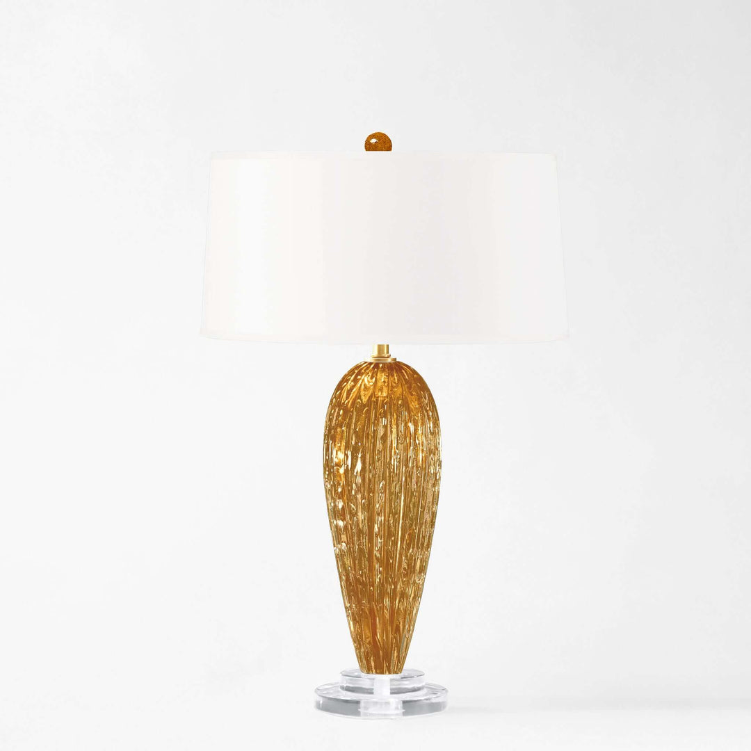 Decorative amber Murano glass table lamp on a white background