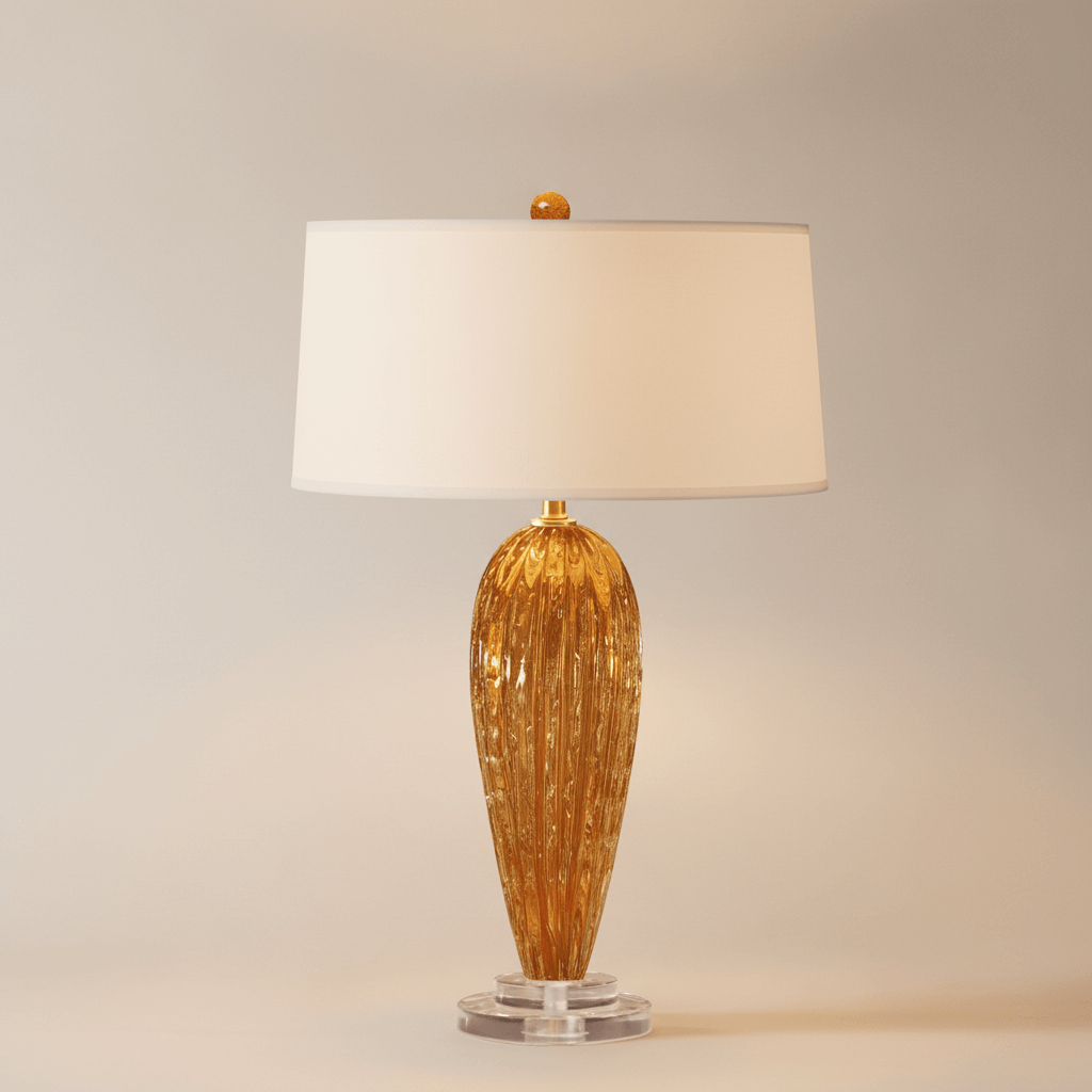 Table lamp with gold base and white shade on a neutral background