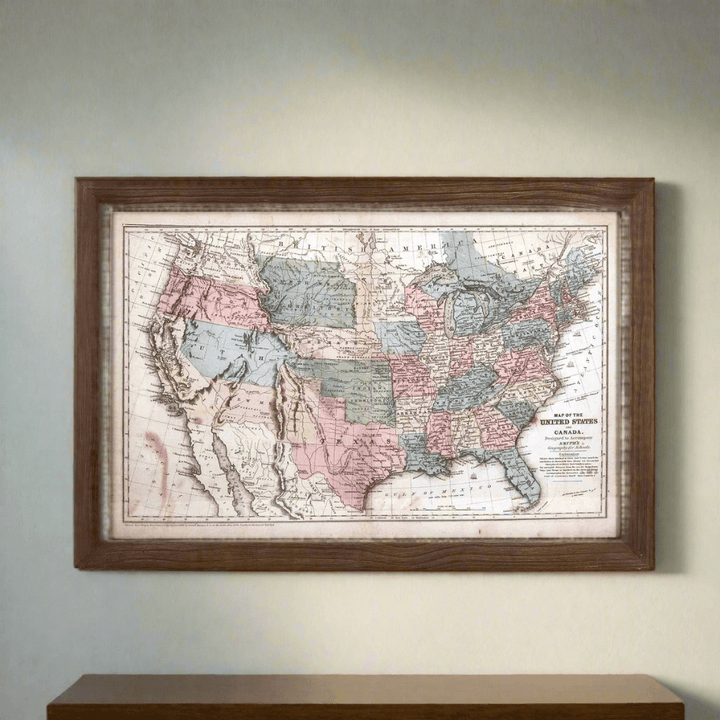 Antique 1850s United States wall map in a dark wooden frame, featuring pastel colors and intricate 19th-century cartography.