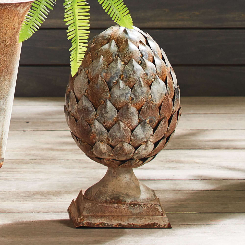Antique artichoke ornament on pedestal base, showcasing Old World charm and crafted from age-worn materials.