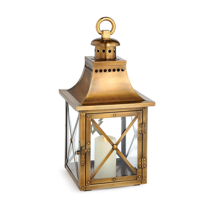 Antique brass lantern with crossbar glass, reflecting historic charm and vintage elegance, featuring a sturdy hanging ring.
