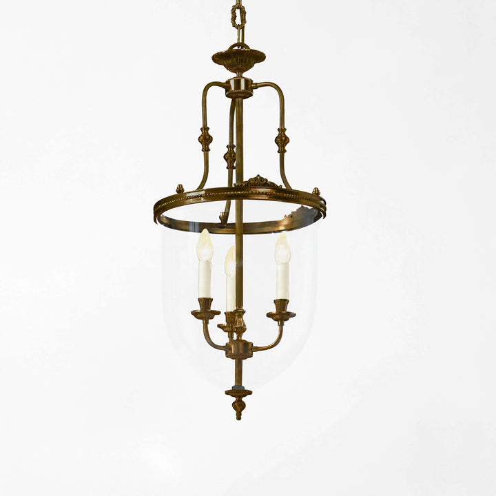 Vintage-style brass pendant light on a white background