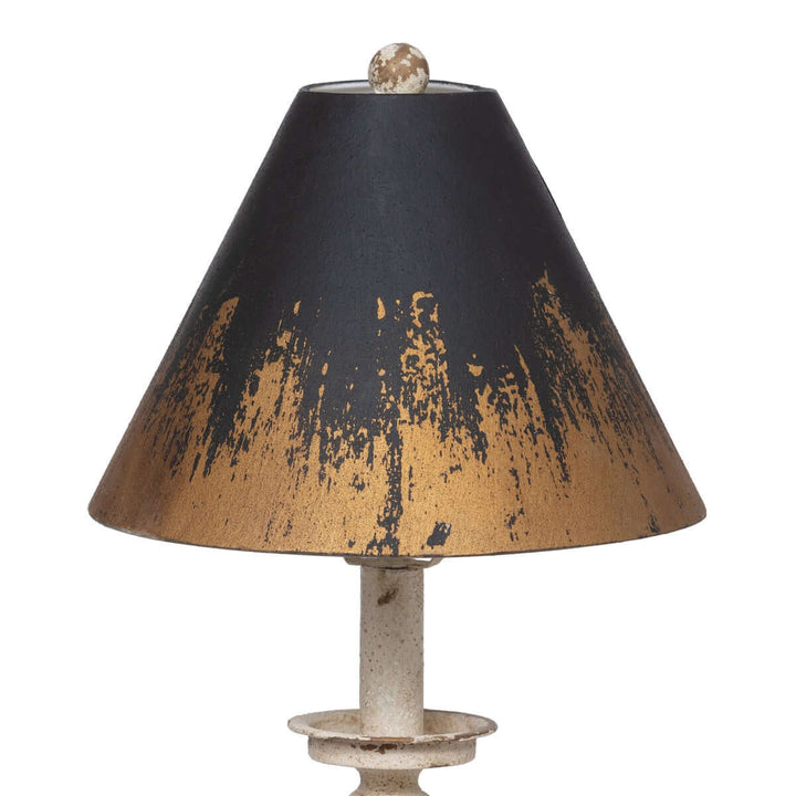 Antique farmhouse distressed buffet lamp with a weathered black and gold shade, offering vintage elegance and warm ambiance.