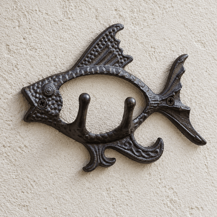 Detail of textured cast iron fins and two curved hangers on a fish-shaped wall hook