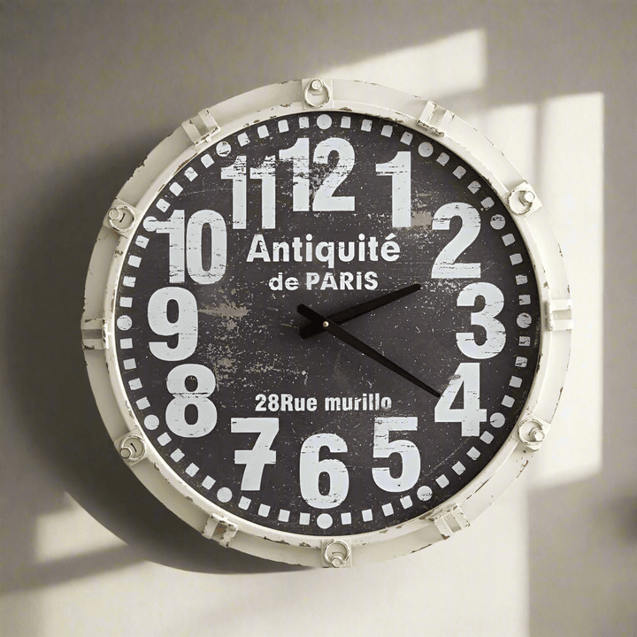 Antique French country wall clock with weathered white frame and vintage numbers, inspired by Parisian elegance.