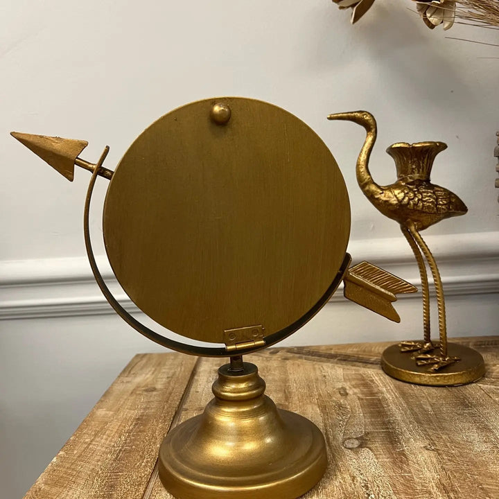Side view of the arrow-shaped tabletop clock and supporting base