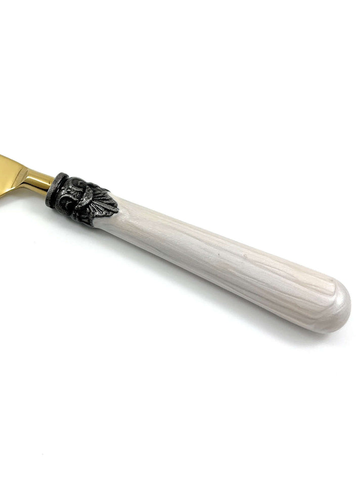Close-up of an Antique Gold Flatware with White Handles, showcasing the elegant design and antique-style accent band.