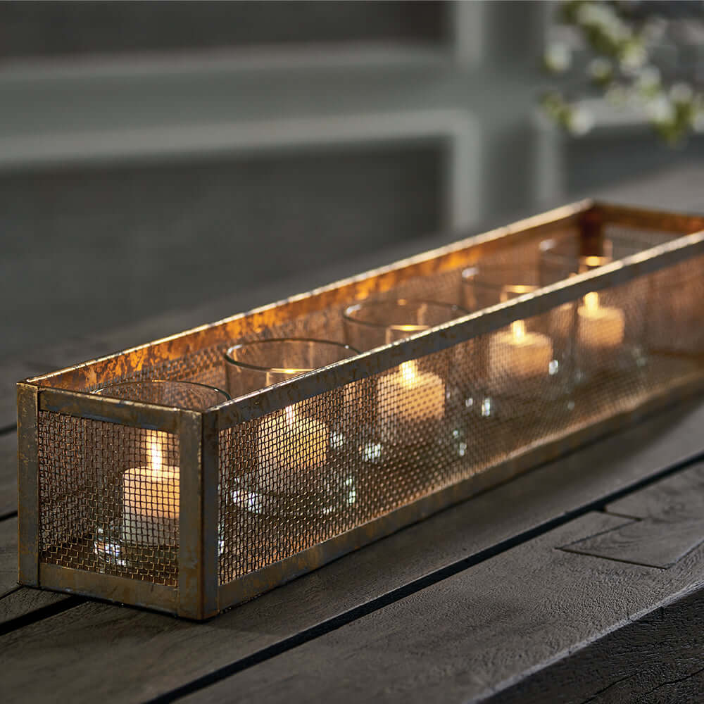 Antique gold mesh candle holder centerpiece tray with flickering candles, showcasing vintage charm and rustic elegance.