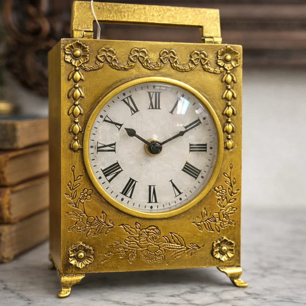 Front detail of the gold table clock and floral ornament